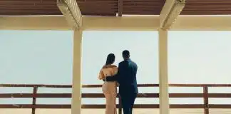 man and woman standing on wooden dock during daytime
